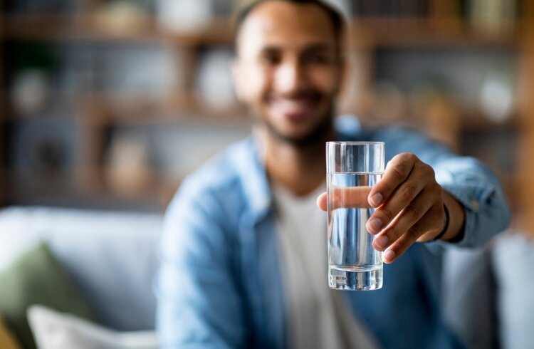 man holding glass of water